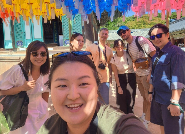 A group of people at a temple with colorful paper lanterns. 5