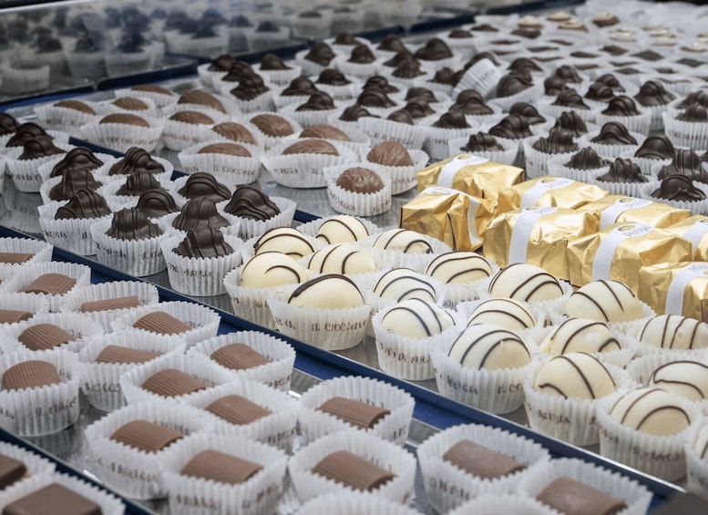 A display of assorted chocolates in paper cups. 3