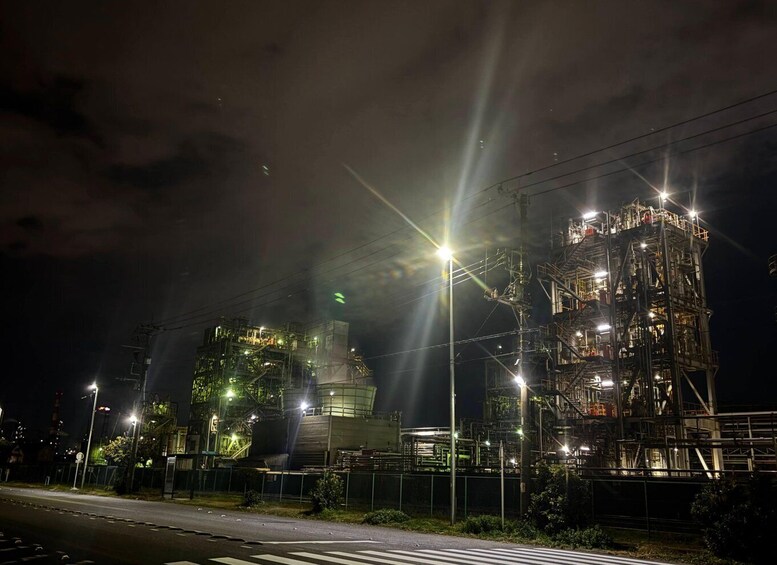 A large industrial facility at night with multiple structures and lighting. 3