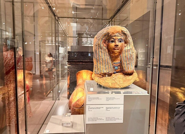 A mummy exhibit with a sarcophagus and a display case. 3