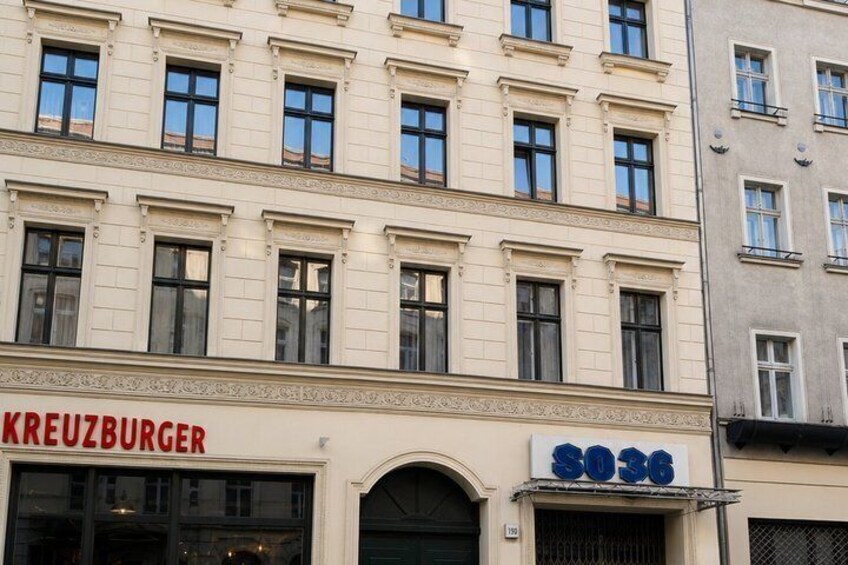 A building with a sign reading 'KREUZBURGER' and another sign with the number '8036'. 2