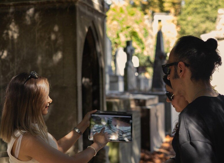 A person holding a tablet displaying a photo, with another person facing the tablet. 3