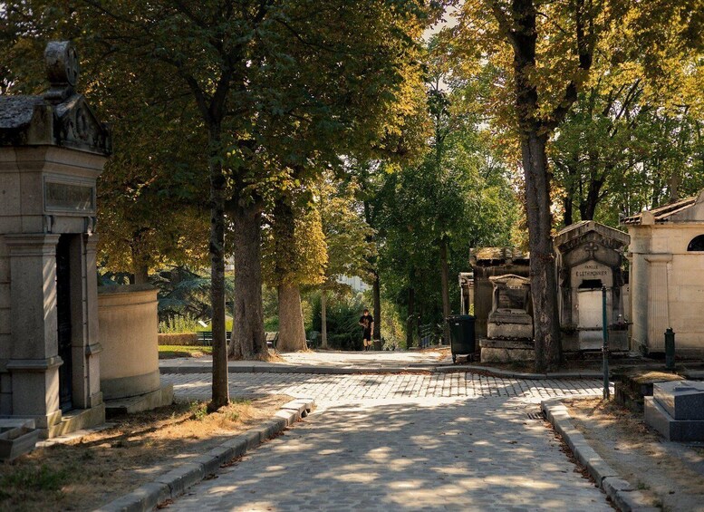 A cemetery with stone headstones and a cobblestone path. 5