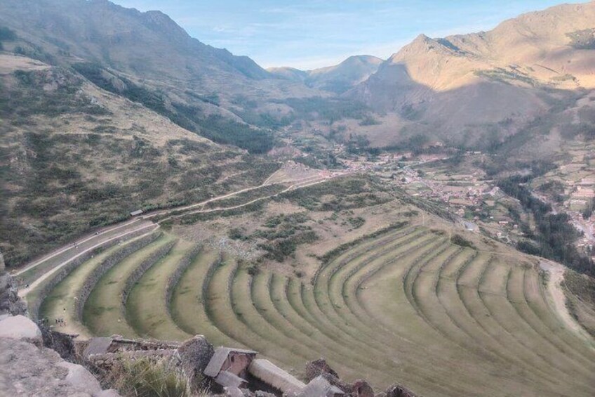 Terraced agricultural fields, a winding road, and a valley with a small settlement. 3