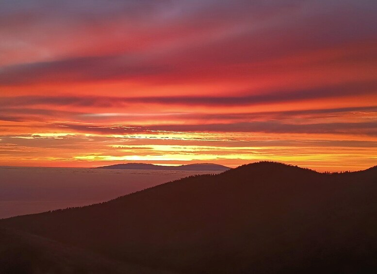 A sunset over a mountainous landscape with a clear sky. 3