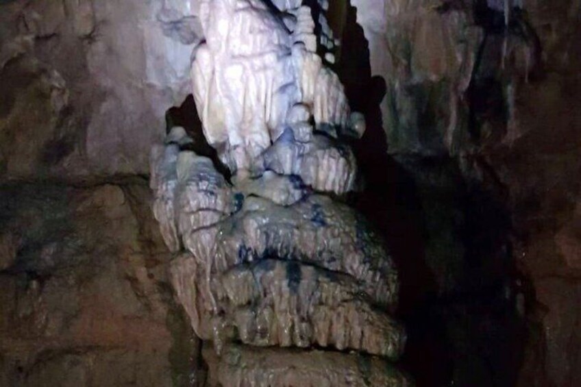 A cave with stalactites hanging from the ceiling. 1