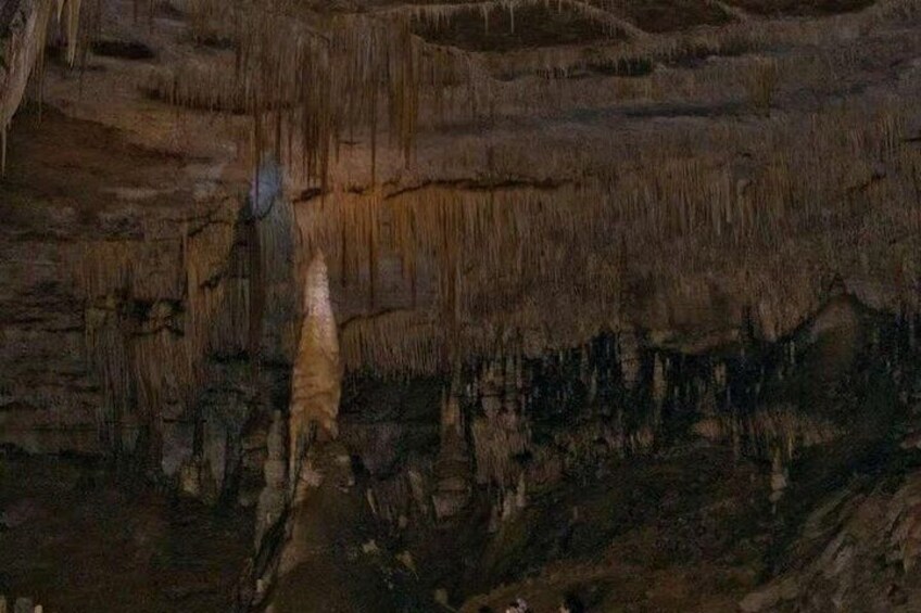 A cave interior with stalactites and stalagmites. 3