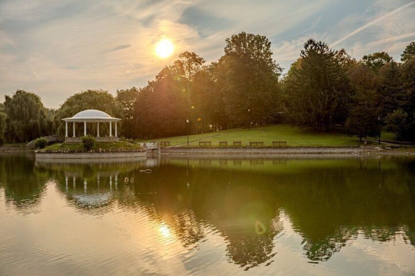 A gazebo, a pond, trees, and a sunset. 3