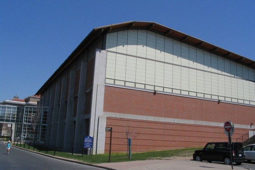A large industrial building with a brick facade and large windows. 2