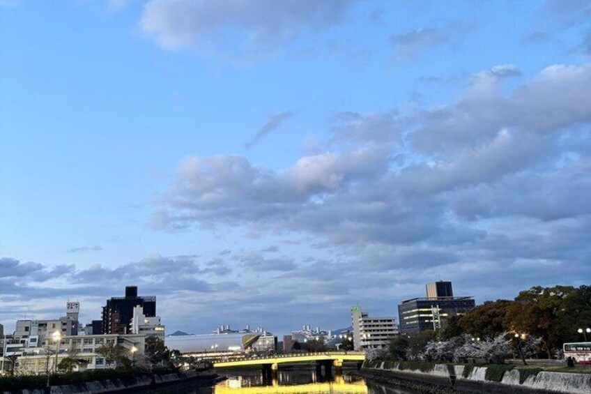 A cityscape with a bridge, buildings, and a river. 4
