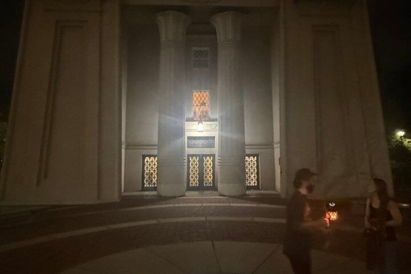 A building with large columns and a central entrance. 4