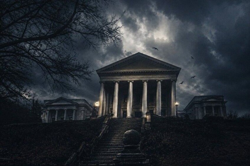 A neoclassical building with columns, under a stormy sky. 1
