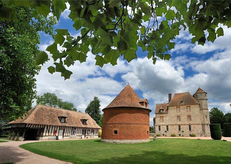 A historic building with a round tower and a large stone structure with a tower. 2