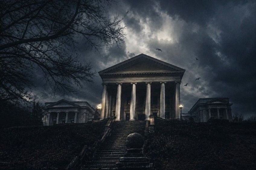 A neoclassical building with columns, under a stormy sky. 1