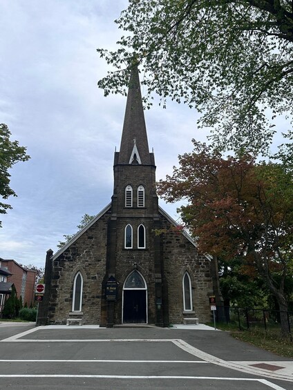 A church with a tall steeple and arched windows. 2