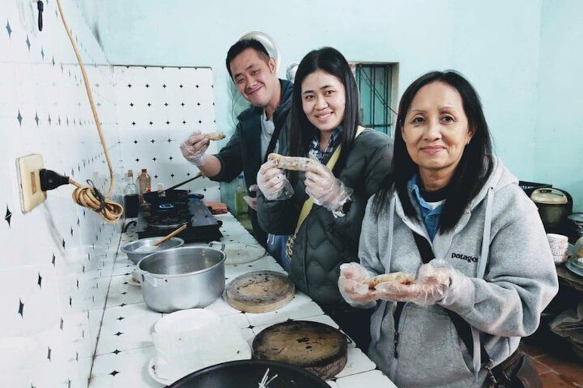 Three people in a kitchen preparing food. 2