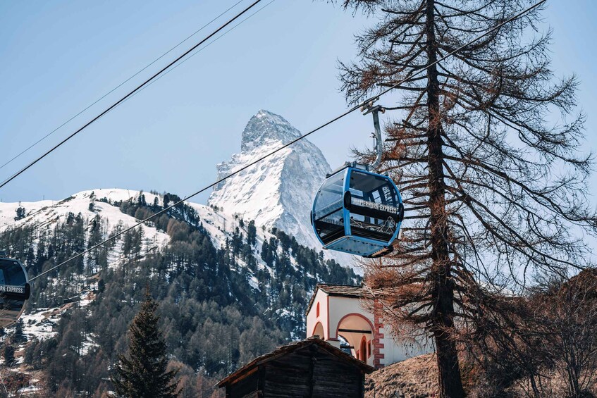 A Matterhorn Express cable car system, a mountain peak, and a small building. 2