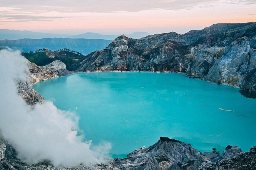 A turquoise lake surrounded by rugged mountains. 2