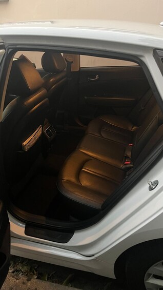 A car's interior with brown leather seats and a visible dashboard. 4