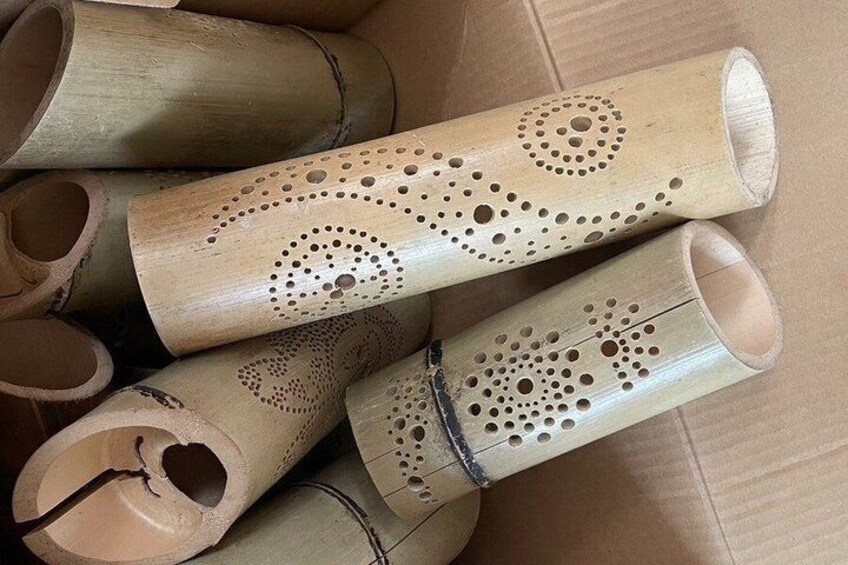 A collection of bamboo tubes with circular patterns. 4