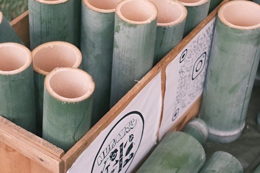 A wooden crate filled with cylindrical objects, possibly pipes or tubes, with a label that reads 'CLUBHOUSE.' 3