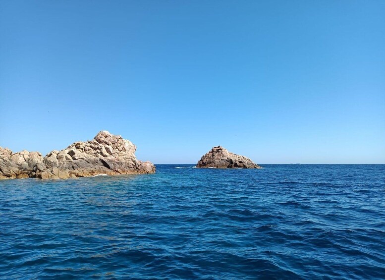 A calm sea with two rocky outcrops. 1