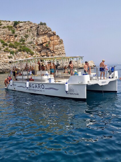 A boat named ZINGARO with passengers enjoying the sea. 1