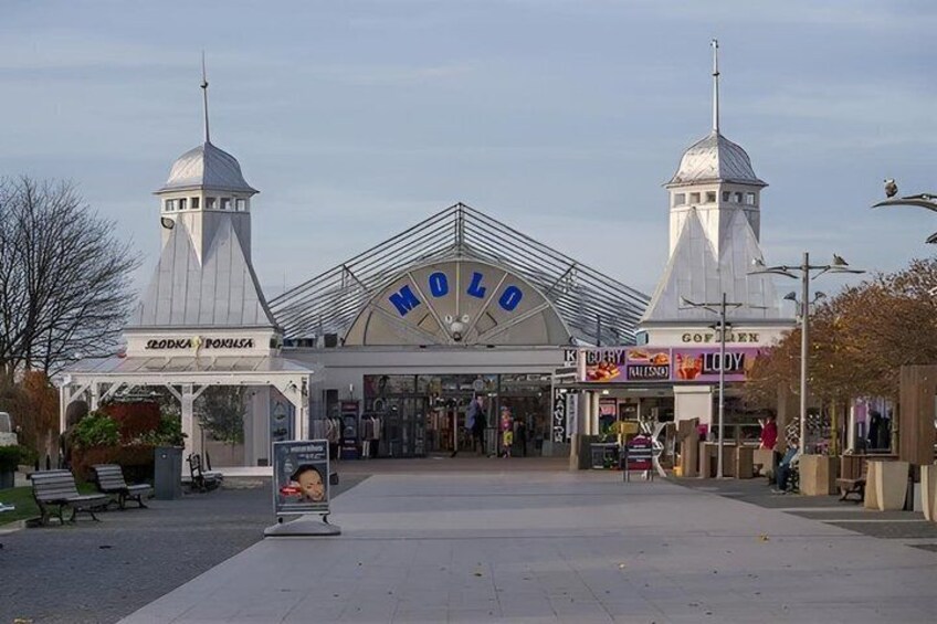 A building with a large sign reading 'MODO' and two towers. 4