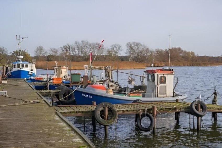 A wooden dock with boats moored at the pier. 3
