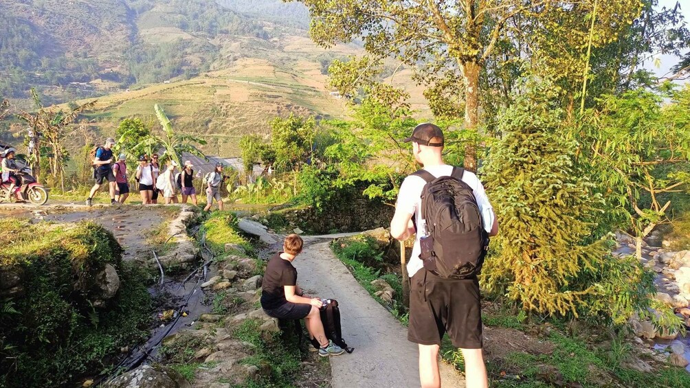 A group of hikers on a trail with a mountainous landscape in the background. 2