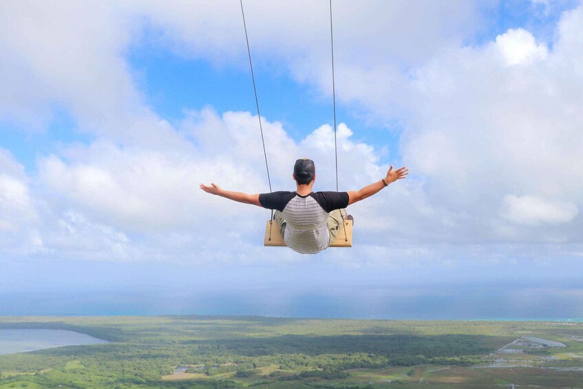 A person swinging on a swing with a landscape in the background. 3