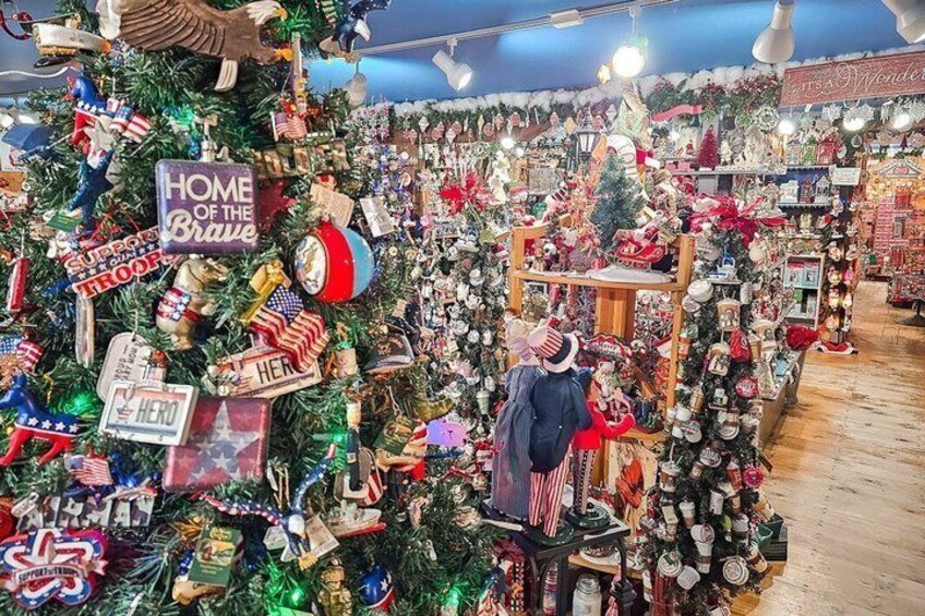 A Christmas tree adorned with patriotic ornaments and a sign reading 'Home of the Brave.' 3