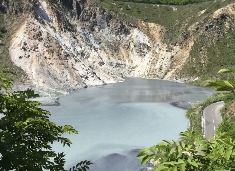 A large crater lake surrounded by steep, rocky cliffs. 2