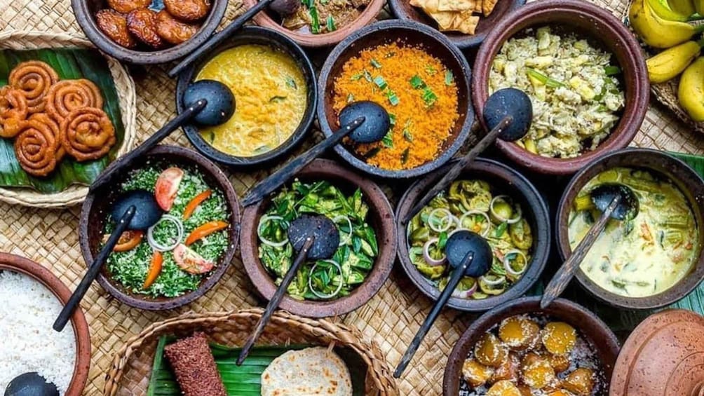 A variety of traditional dishes in clay pots, some with vegetables and others with different textures and colors. 1