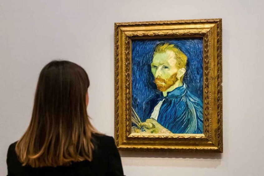 A person viewing a painting in a gallery. 5