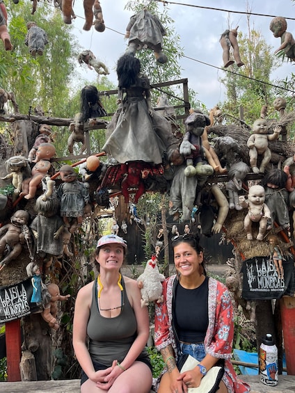 A collection of dolls and figures arranged on a wooden structure, with a sign reading 'LAISLA DELAS NUNERIAS.' 4