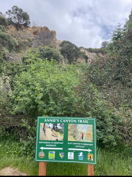 A trail sign for Annie's Canyon Trail with directions to a moderate and a difficult viewpoint. 2