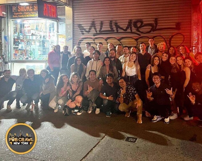A group of people posing in front of a graffiti-covered wall with a store in the background. 3