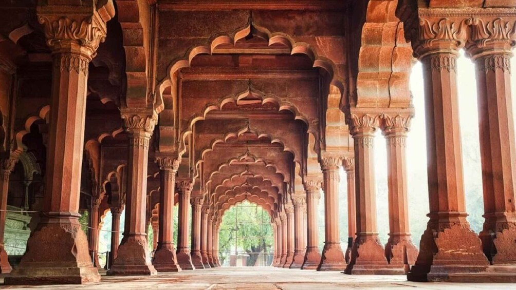 An interior with a series of arches and columns, leading to a central open space. 4