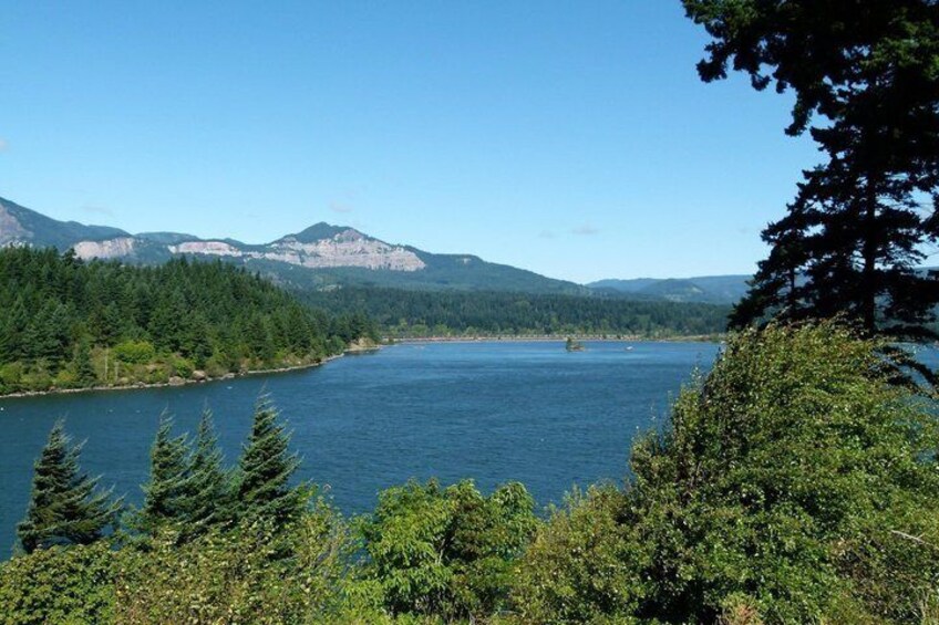 A lake surrounded by dense forest and mountains. 4
