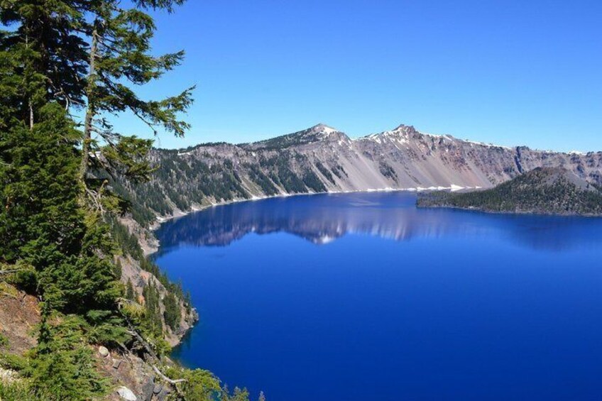 A mountain lake surrounded by forested slopes. 3