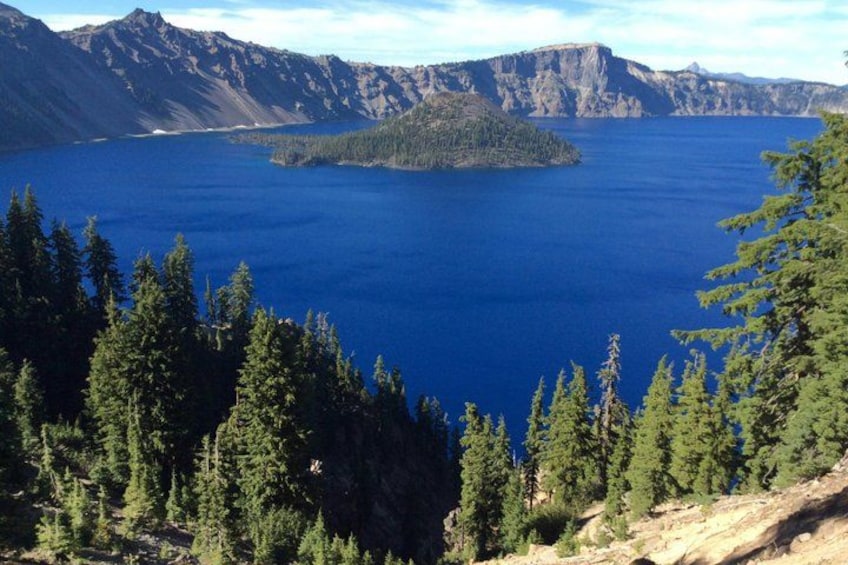 A lake surrounded by mountains and dense forest. 3