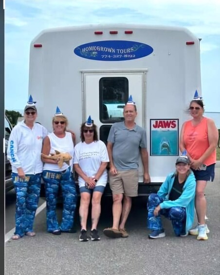 A group of people standing in front of a vehicle with 'HOMEGROWN TOURS' and a phone number on it. 1
