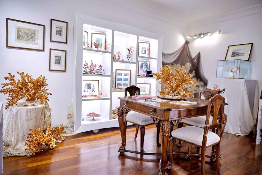 A dining room with a wooden table, chairs, and a glass display case. 3