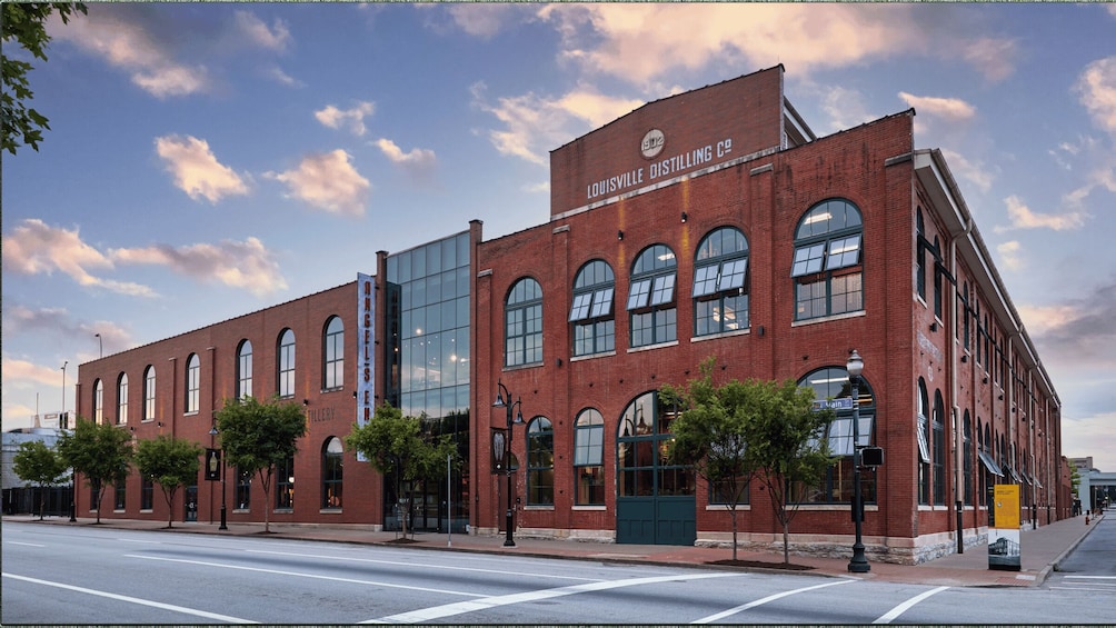 A historic brick building with large windows and a glass extension, labeled 'Louisville Distilling Co.' 2