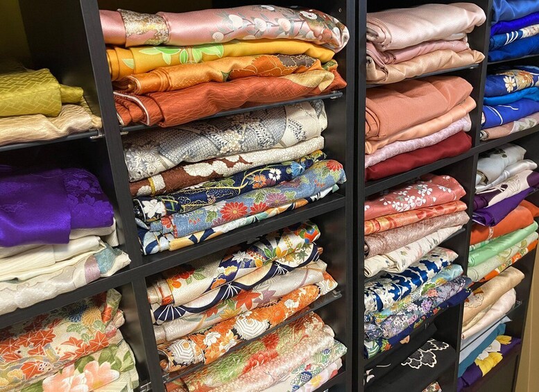 A variety of folded fabrics on shelves. 5