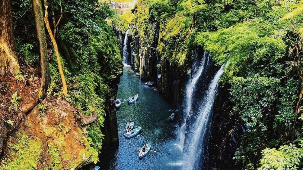 A river with multiple waterfalls and people kayaking. 1