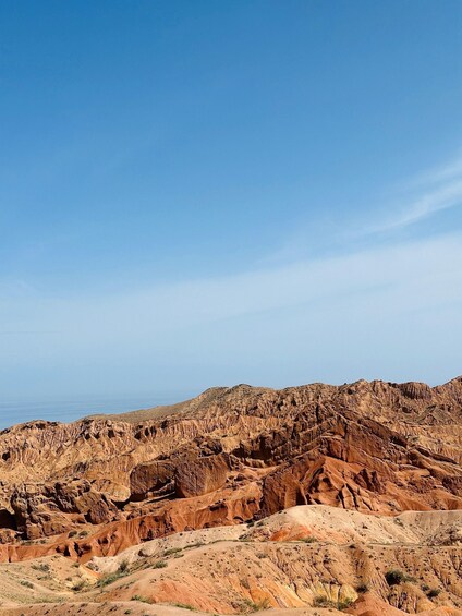 A rugged mountainous landscape with a clear blue sky. 5