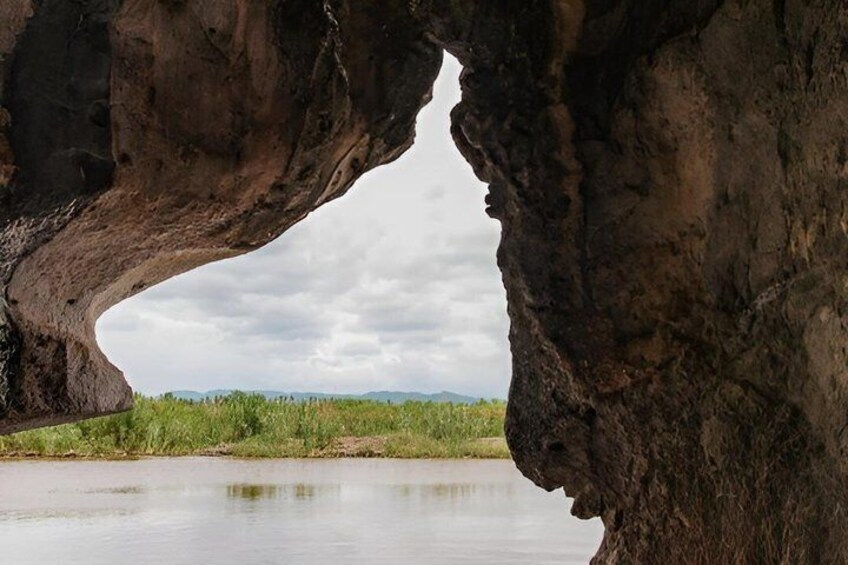 A natural rock formation with an archway over a body of water. 5