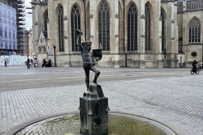 A statue on a pedestal in a square with a historic building in the background. 3